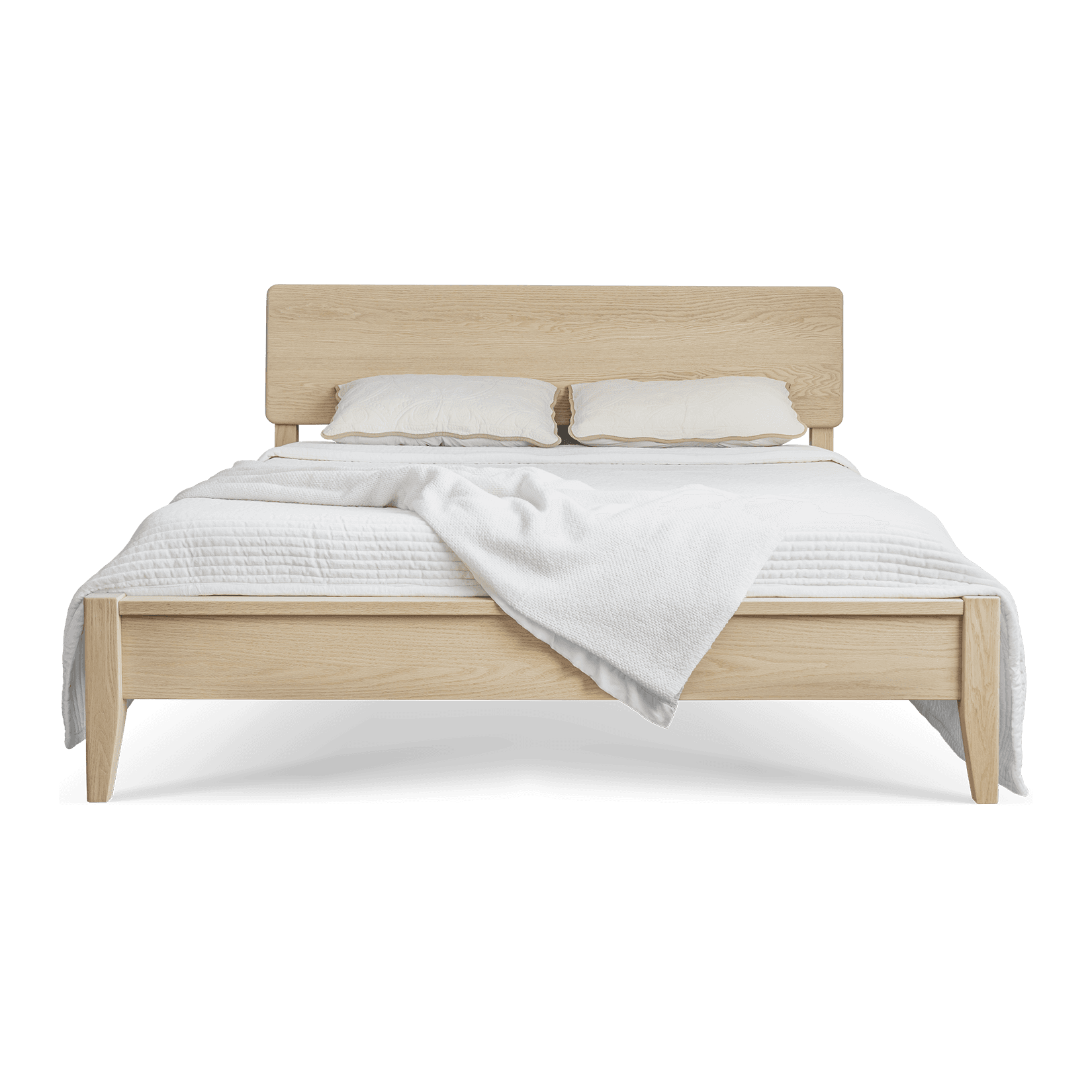 A solid oak bed with cream linens